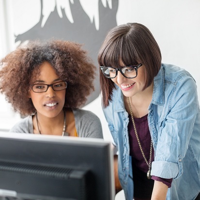 Young women working together on computer