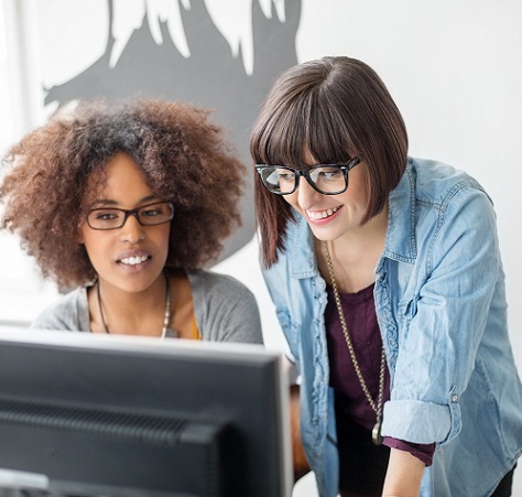 Young women working together on computer